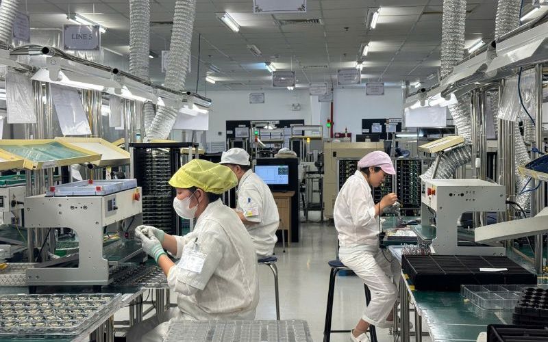 Factory workers at workstations in Vietnam’s contract manufacturing sector.